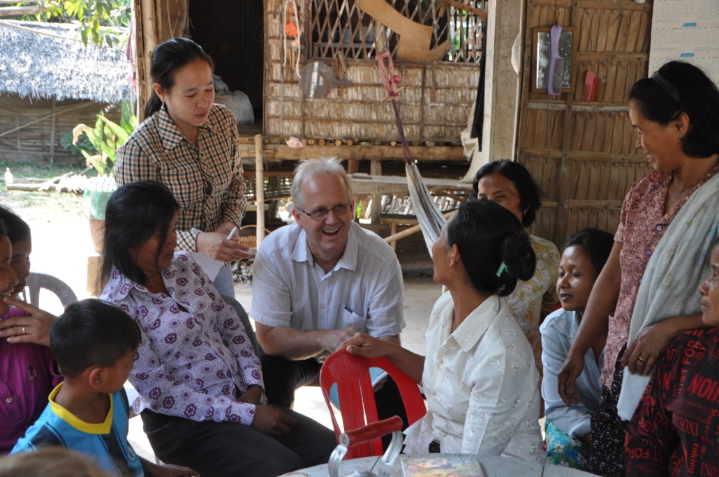 Arnt, secretary general of Norwegian Mission Alliance, chats with community members in a World Renew target community.