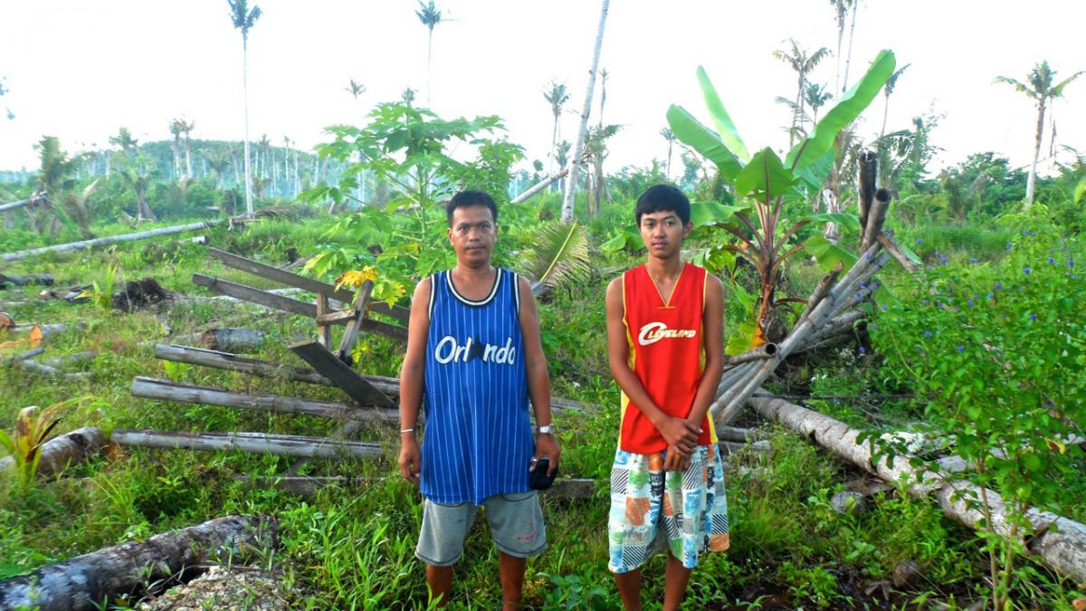 Von and his son in front of what remains of their pre-Yolanda home.