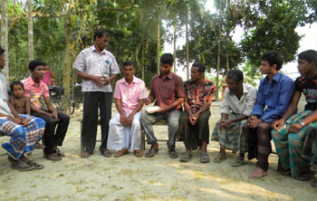 Anwar (seated, center, pink shirt) has been part of a primary group for many years. Recently, he and a woman from another primary group, took out a loan from the Central Committee and started a poultry business.