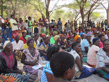 Beneficiaries enjoying time fellowshipping together while waiting for the truck to arrive.
