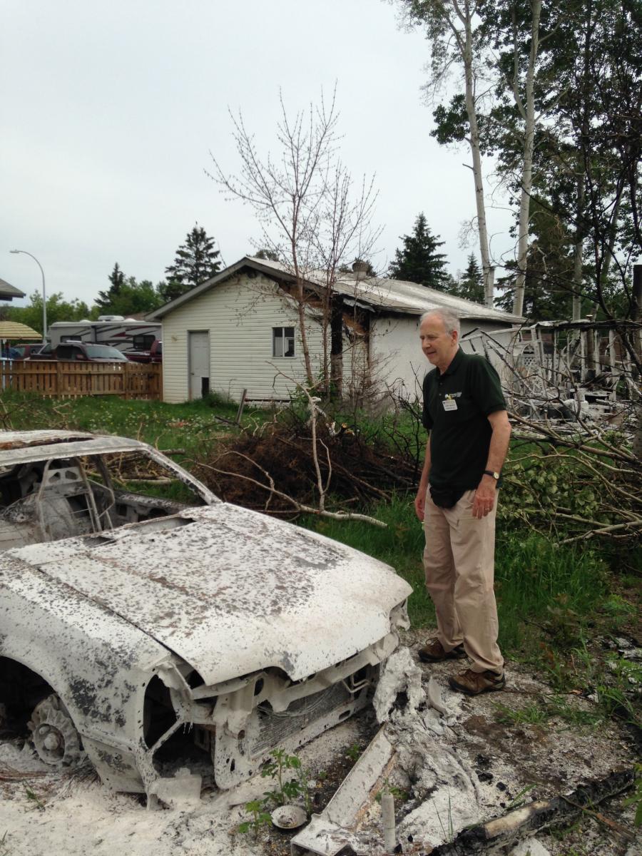 DRS volunteer Henry Visscher surveys the damage done in Fort McMurray.