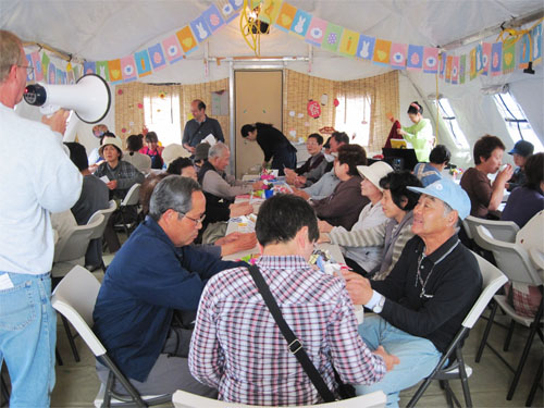 Survivors of the 2011 earthquake enjoy a bingo game at a community event