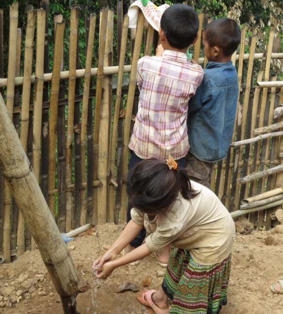 Young students practicing handwashing.