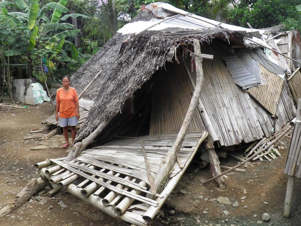 Merna standing in front of her collapsed home