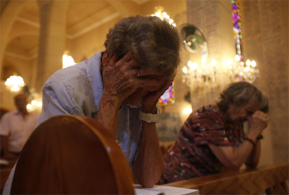 Christians pray in the Basilica of our Lady of Fatima in Cairo in Cairo August 18, 2013. Egypt's Coptic Christians, who make up 10 percent of its 85 million people, have coexisted with the majority Sunni Muslims for centuries. Violence erupted periodically, especially in the impoverished south, but the attacks on churches and Christian properties in the last week are the worst in years. Picture taken August 18, 2013. Photo credit: Amr Dalsh