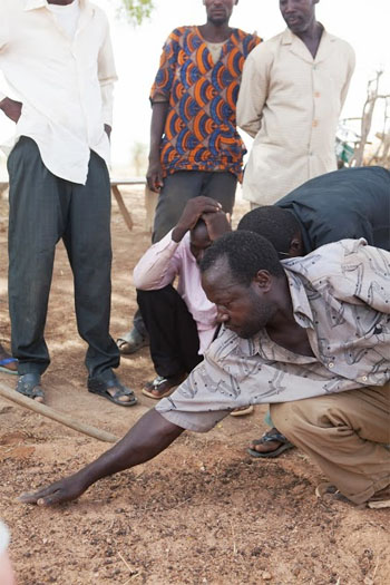 Galdji demonstrates the SRI method to others. Photo Credit: Sean Hawkey