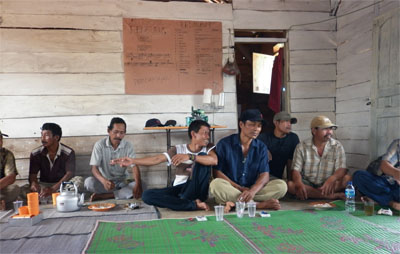 Moro-Moro people having a community organizing meeting at a camp for displaced persons