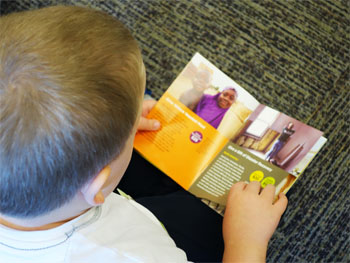 A child used World Renew’s gift catalog to go “shopping” during children’s worship and select items that could help those in need.