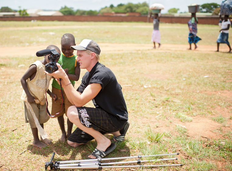 Ryan Gelensye teaches two boys in Malawi about his camera   photos by Karmen Meyer