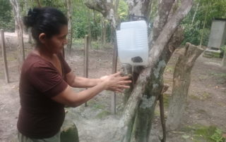 Nicaraguan woman washing hands from a bottle of clean water