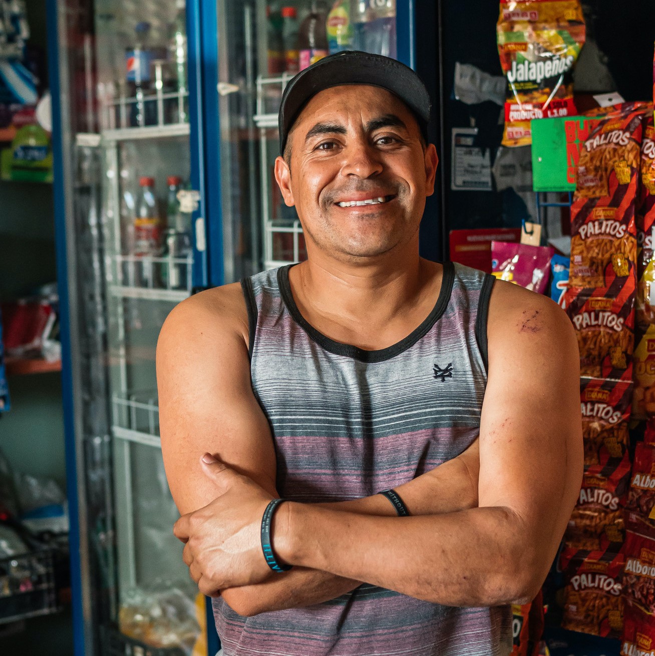 Close up photo of a Honduran man smiling in a grocery store