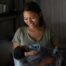 Honduran mother smiling down at her newborn baby