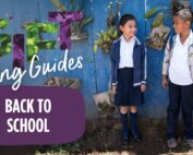 two smiling kids standing side-by-side with backpacks on with colorful words spelling out Gift Giving Guides Back to School