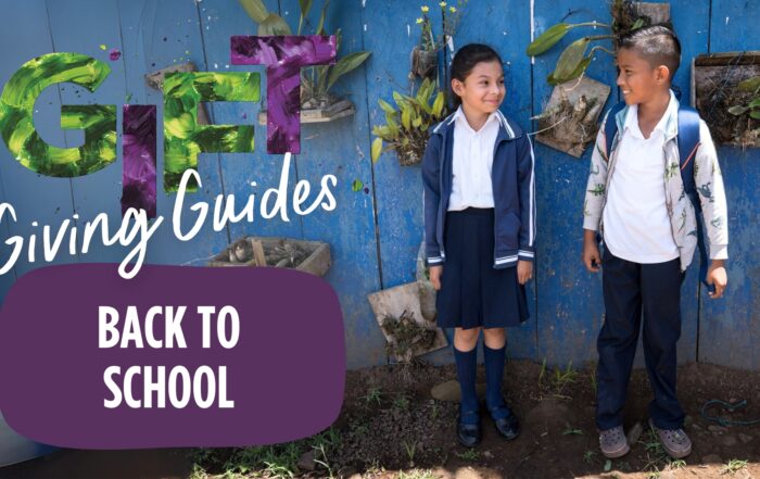 two smiling kids standing side-by-side with backpacks on with colorful words spelling out Gift Giving Guides Back to School