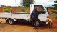 Mozambique man stands in front of white truck