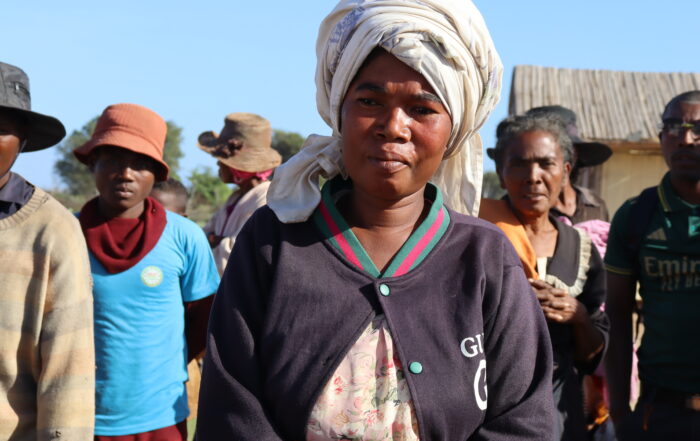 Farmer woman in Madagascar surrounded by family