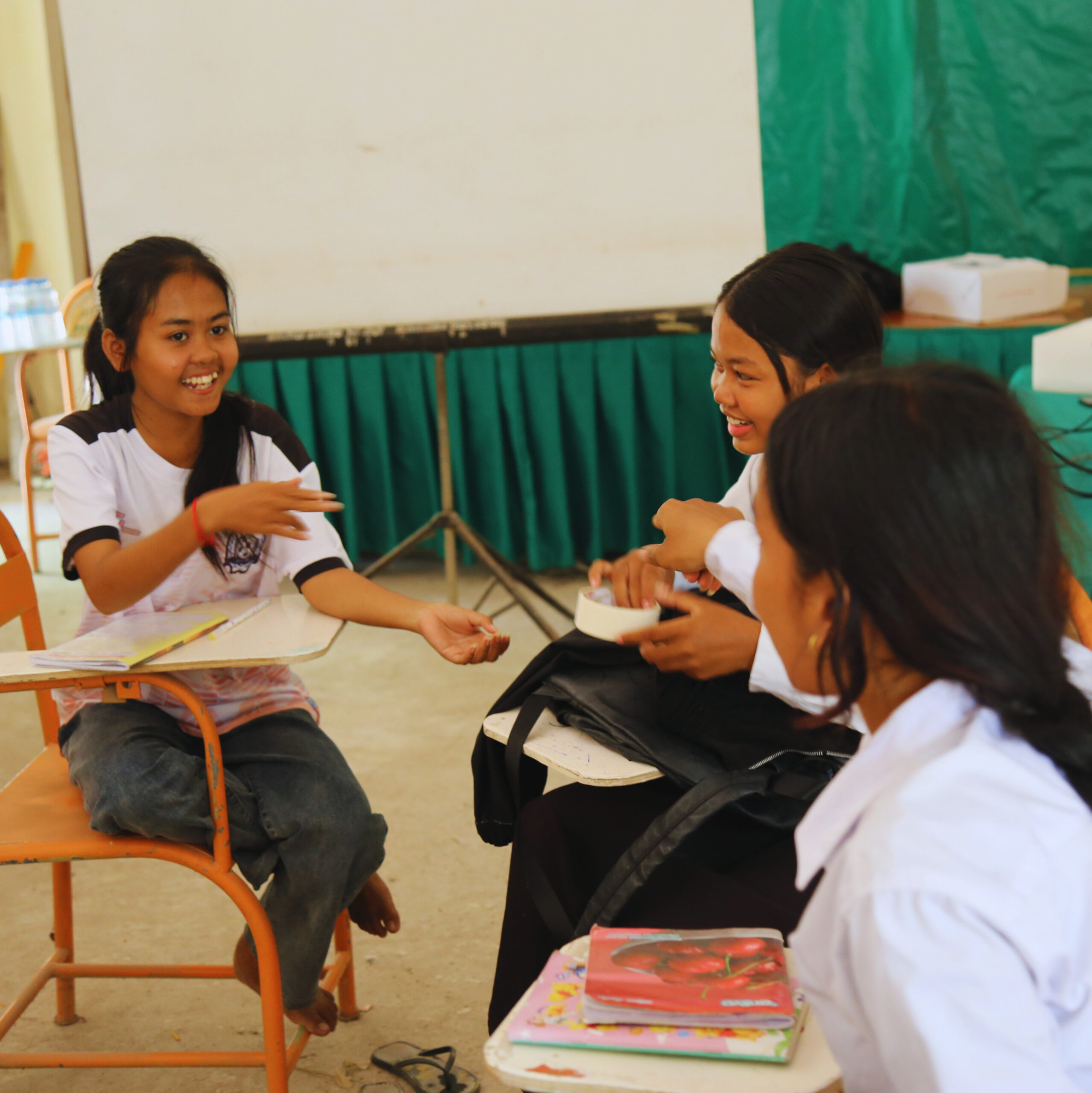girls sitting in semi-circle in a classroom
