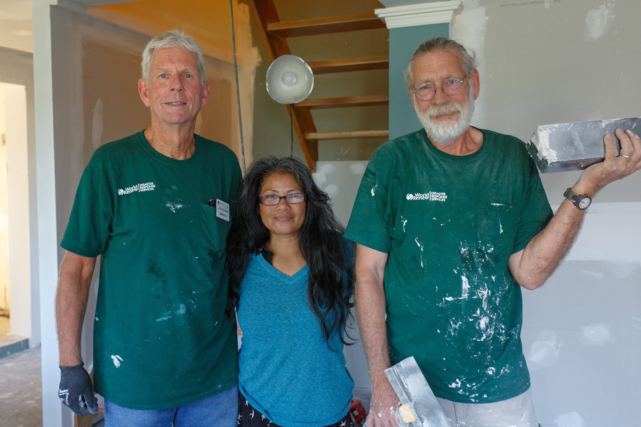 volunteers on home repair site with homeowner