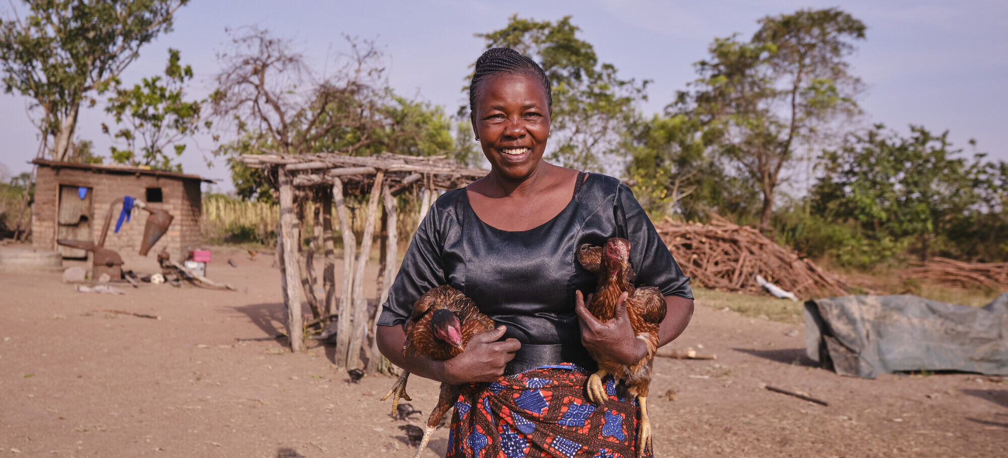 RS46603_RS9845_2025 07 09 – AICT Geita IFSL Project – KB Mpofu 170_lpr A woman holds chicken