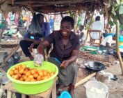 woman selling donuts at market