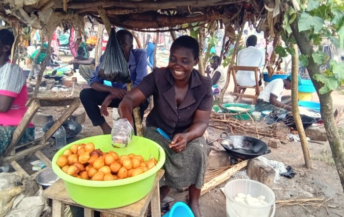 woman selling donuts at market