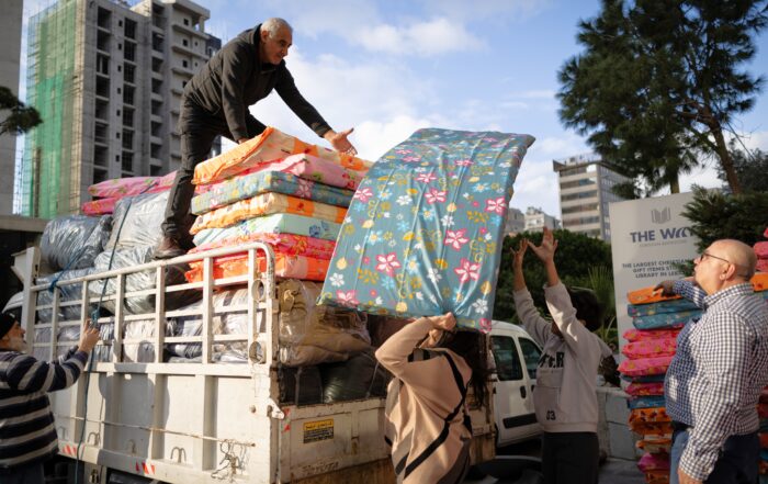humanitarian workers unloading mattresses from truck